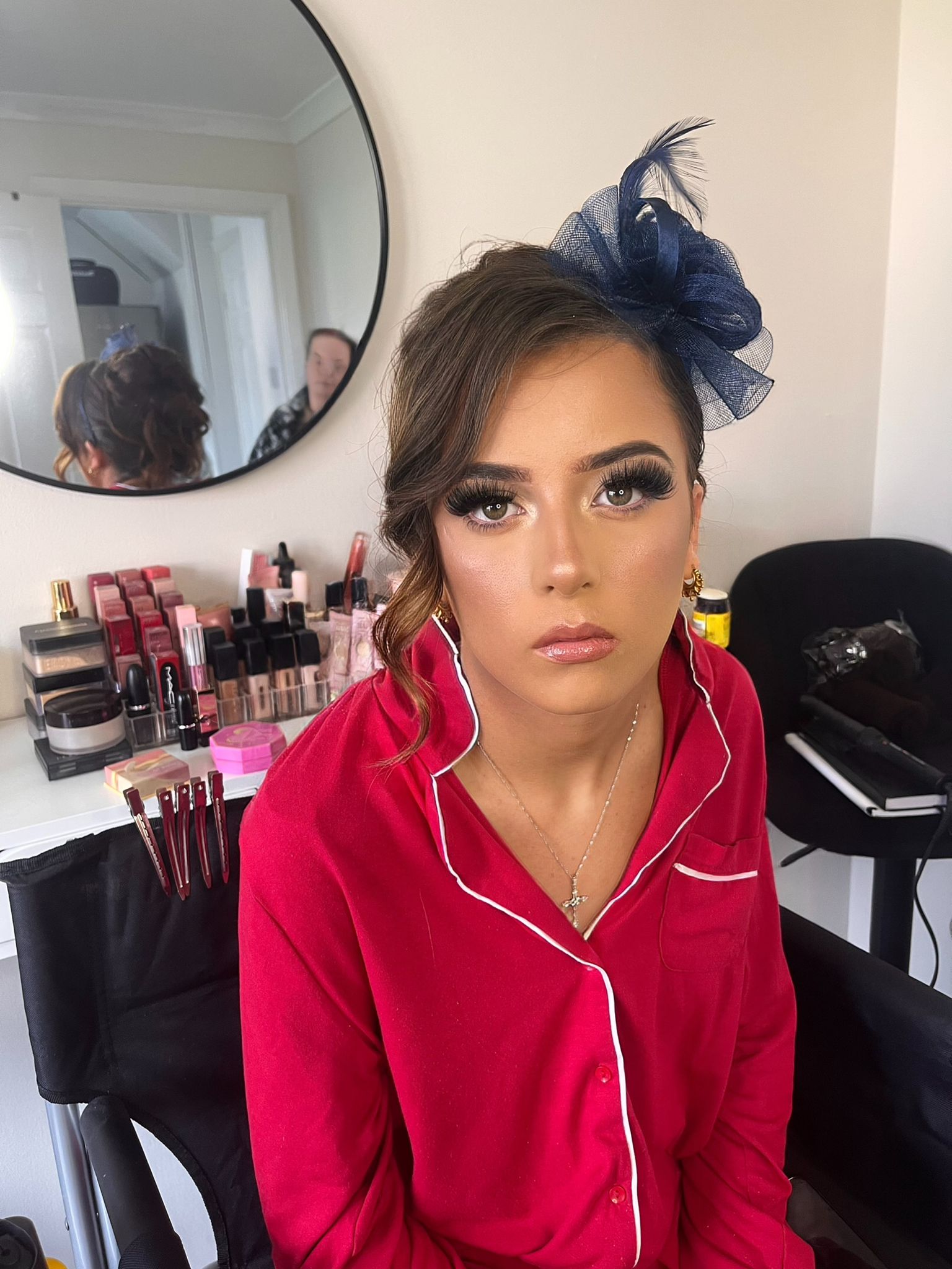 Occasion makeup with red outfit and fascinator