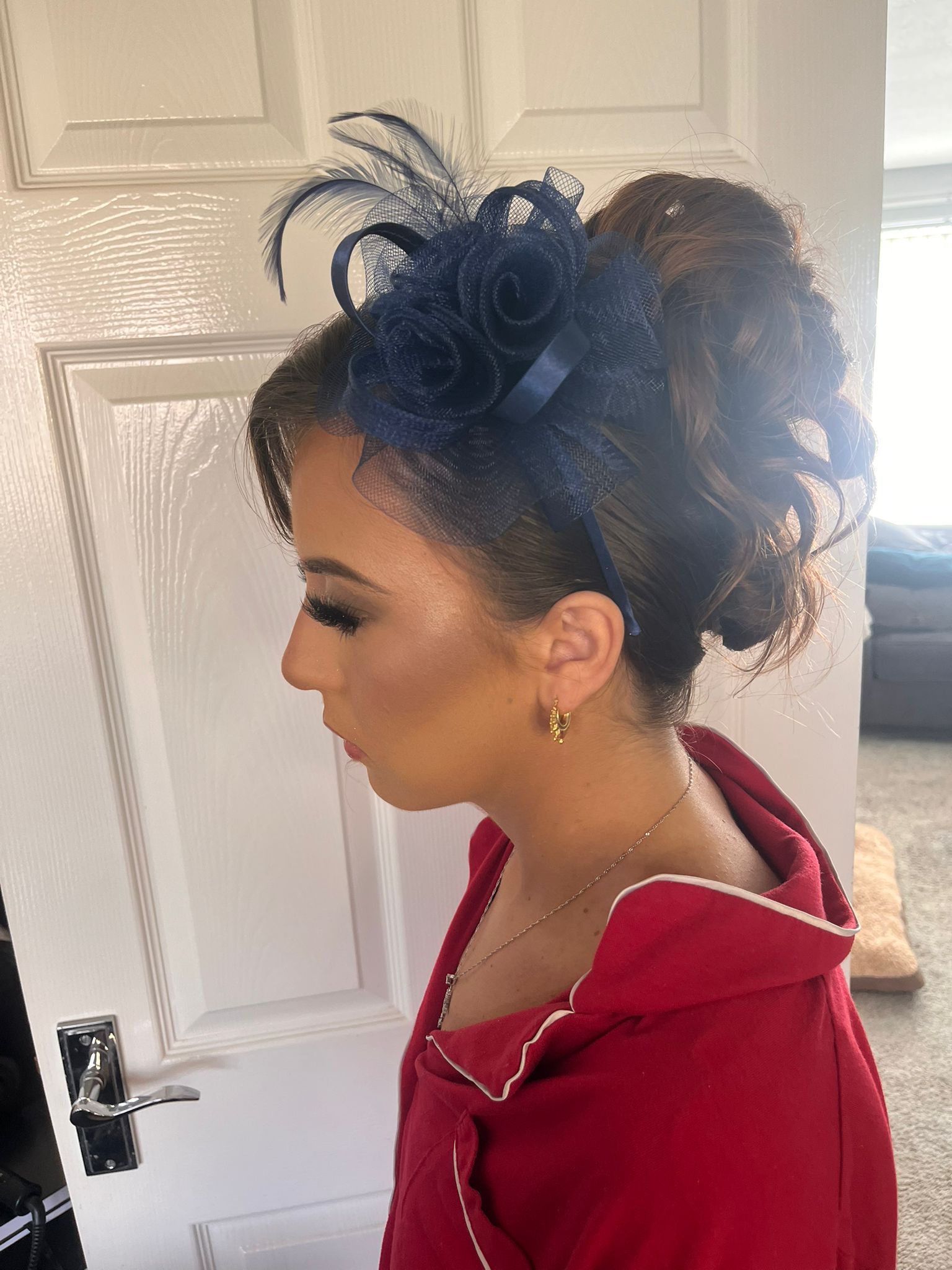 Occasion hair styling with a red fascinator