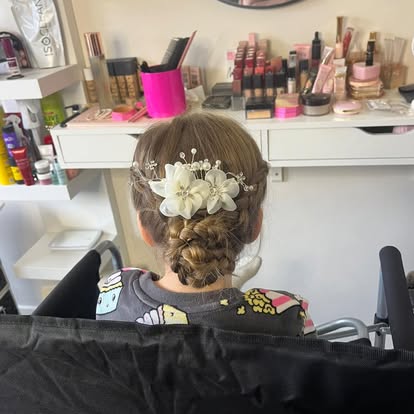 Low bun hairstyle finished with floral accessories